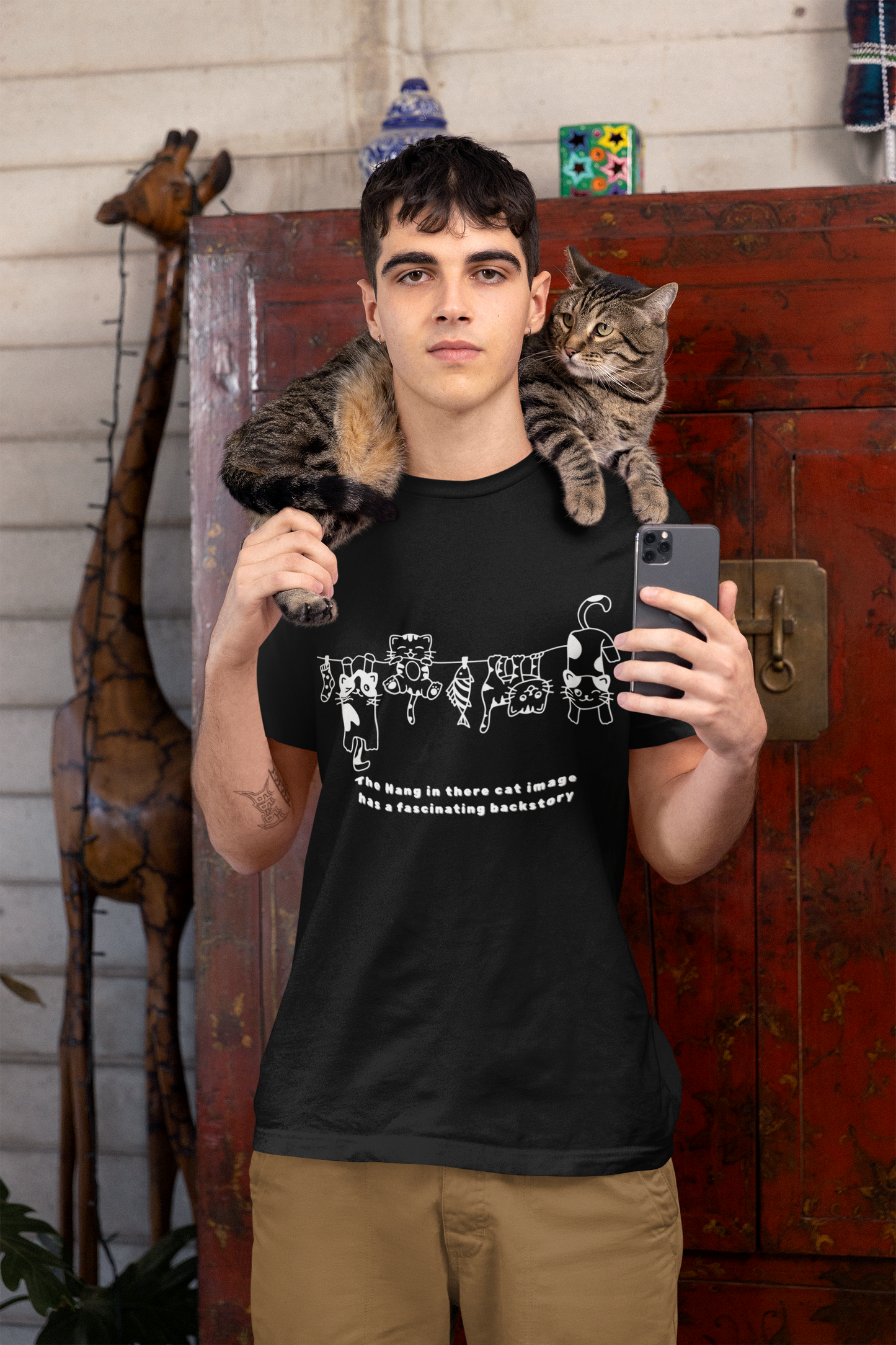 The Hang in There image has a fascinating backstory, cat T-shirt.